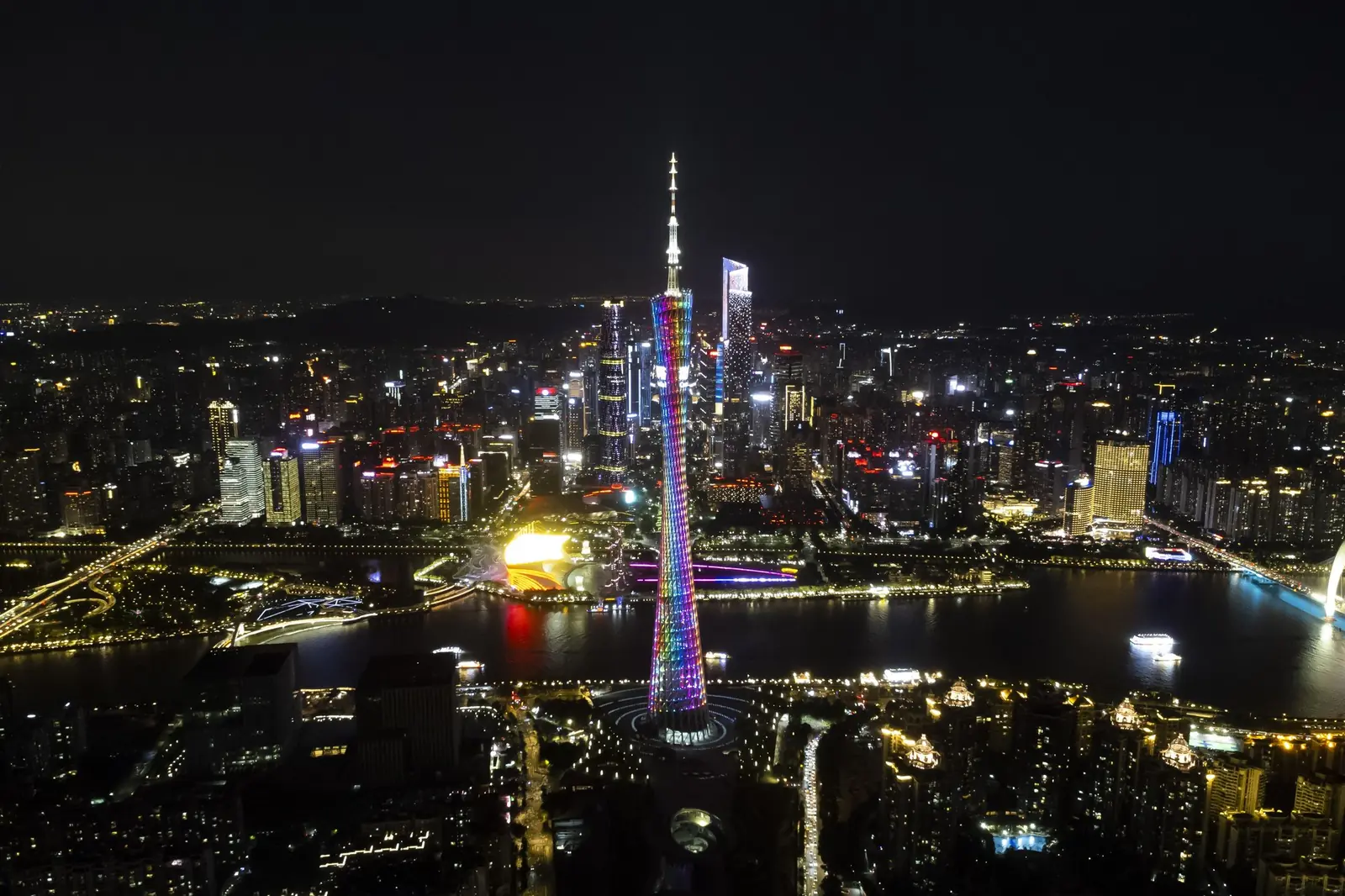 The Canton Tower lit in rainbow colours above Guangzhou's skyline at night